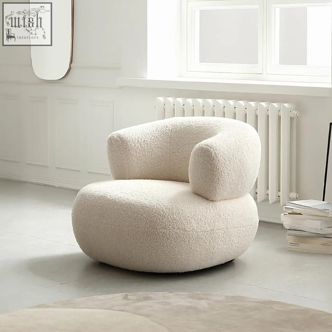 Cream-colored plush sheepskin deirdre armchair in white boucle with rounded cushioned form and cozy design