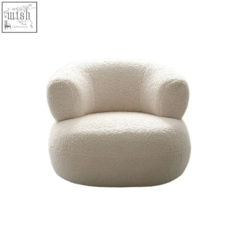 Deirdre armchair in white boucle with cream-colored plush sheepskin style and soft rounded contours