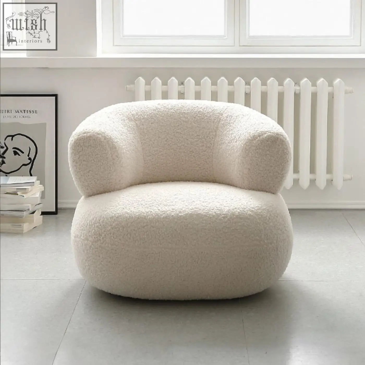 Cream-colored deirdre armchair in white boucle with plush sheepskin style and cozy rounded contours
