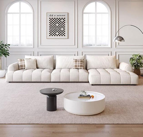 Cream tufted delilah violet two seater sectional sofa with plush cushions and plaid accent pillows four seater sofa