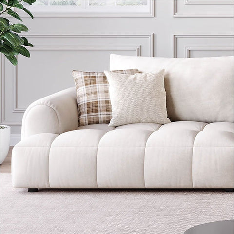 Cream-colored delilah violet two seater sofa with plush tufted cushions and two decorative pillows, four seater sofa option available