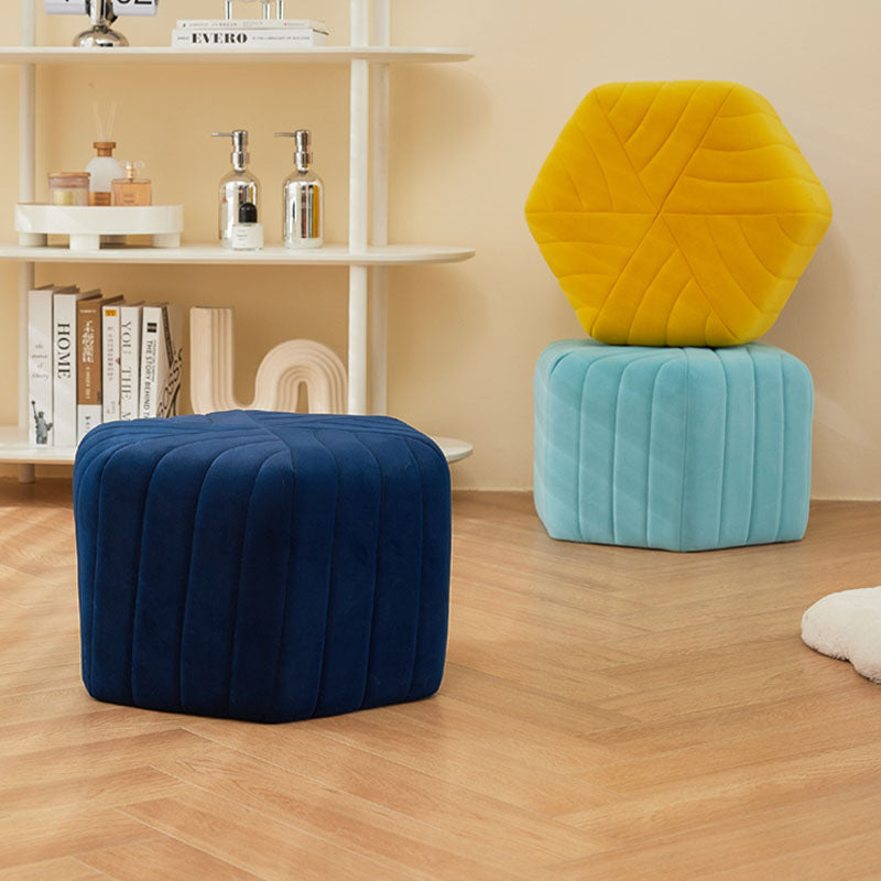 Navy blue velvet della footstool with hexagonal shape and vertical stitched panels for stylish seating or footrest