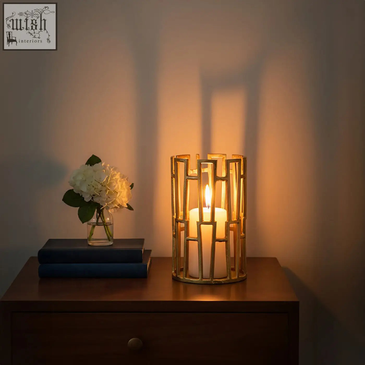 Gold-toned delphi aluminium candle holder with geometric design and white pillar candle inside
