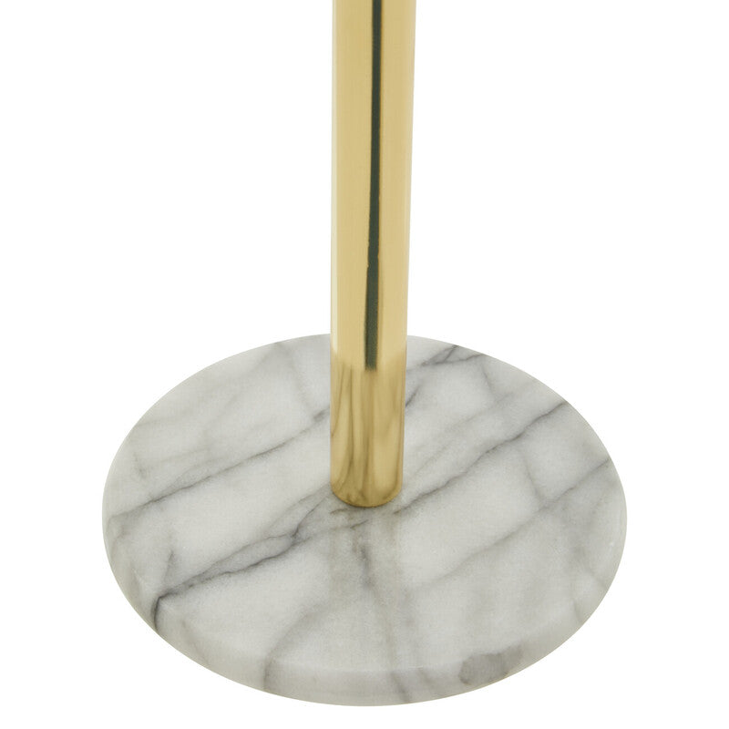 Delphine gold kitchen roll holder with gold-toned pole mounted on a white marble base with gray veining