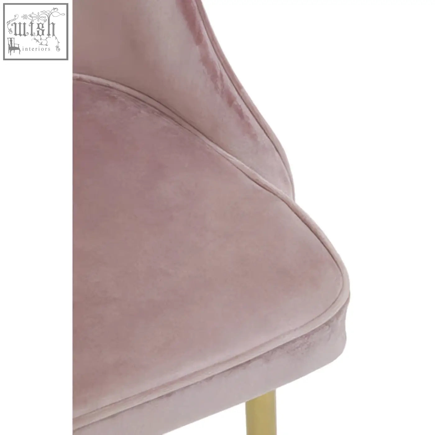 A soft blush pink velvet dining chair with sleek modern design and gold toned legs perfect as a pink velvet chair