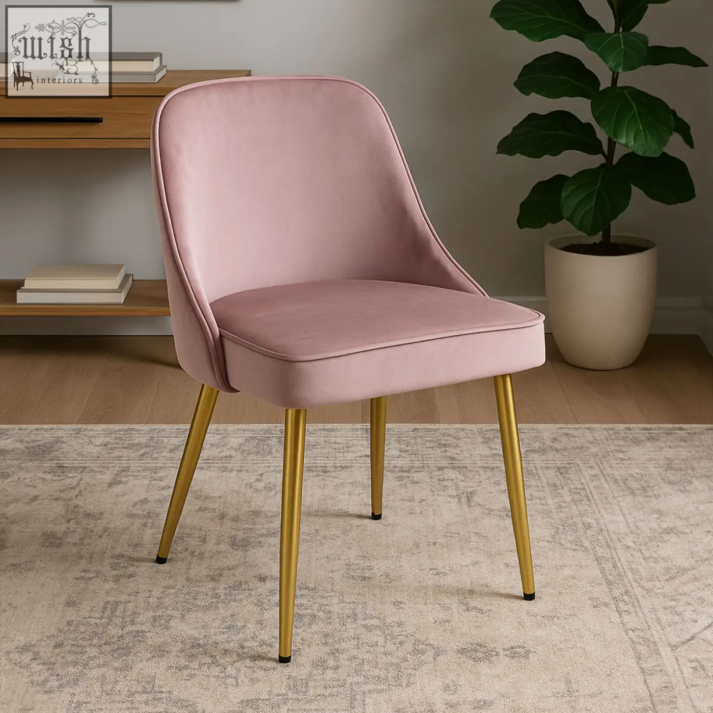 A soft pink velvet chair with slender gold metal legs perfect as a dusky pink velvet dining chair