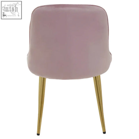 Soft pink velvet chair with slender gold-tone legs perfect as a dusky pink velvet dining chair