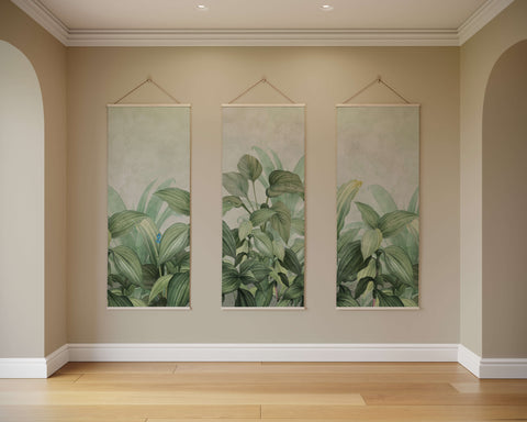 Three vertical dense jungle tapestries with lush green leaf patterns hanging symmetrically on a beige wall