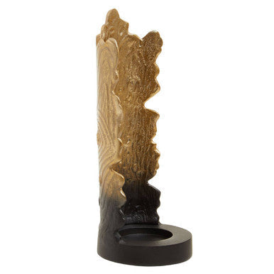 A tall intricately carved wooden candle holder with deomali small ombre black and gold gradient finish