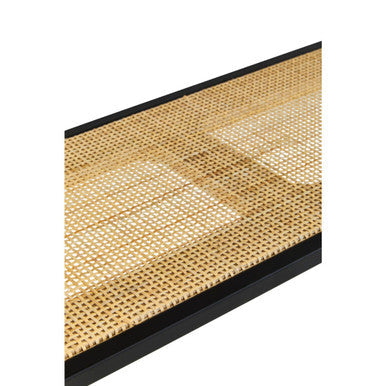 Black-framed woven cane table mat with natural beige texture on a two tier rattan and metal wall shelf