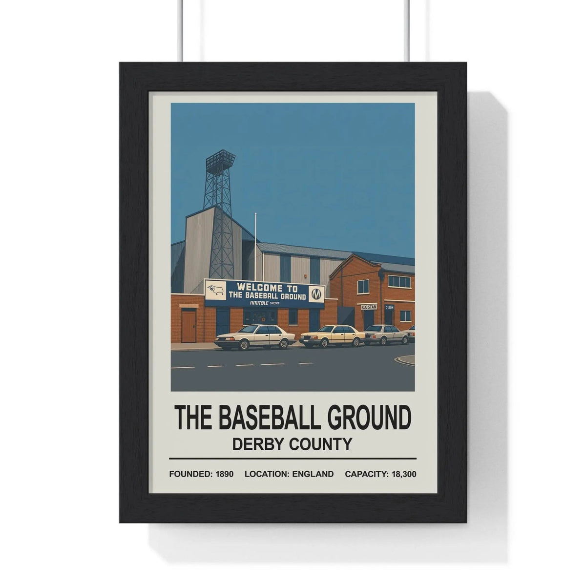 Black-framed derby county baseball ground print showing the stadium with vintage cars parked outside under blue sky