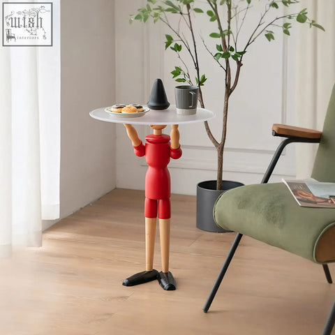 Red solid wood derby pinocchio puppet side table holding a white circular tray with its arms for stylish storage