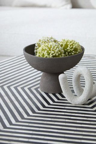 Gray ceramic pedestal bowl with textured grey matte finish and small pedestal base perfect for serving or decor