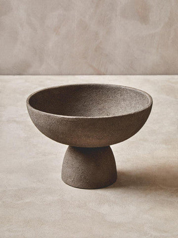Gray textured ceramic pedestal bowl with a small base perfect for stylish serving or display in textured grey finish