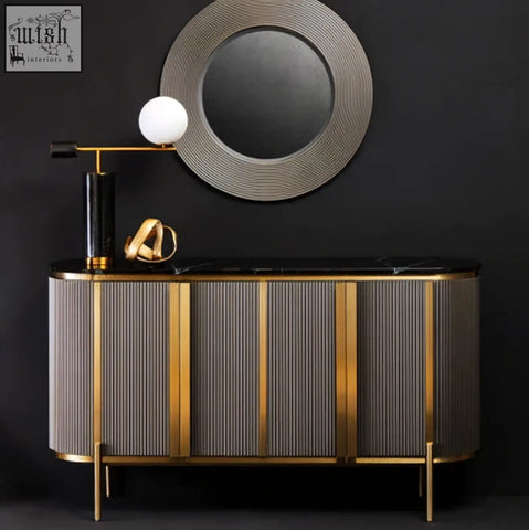 Gold-framed console table with vertical ribbed grey and black panels matching the dervio grey four door sideboard with black marble top