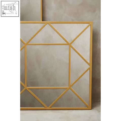 Descartes gold frame wall mirror with a gold frame and modern geometric angular design for stylish wall decor