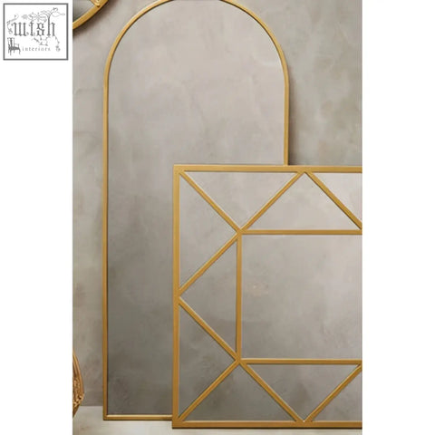Descartes gold frame wall mirror with gold-toned geometric design featuring an arched top and rectangular frame wall mirror