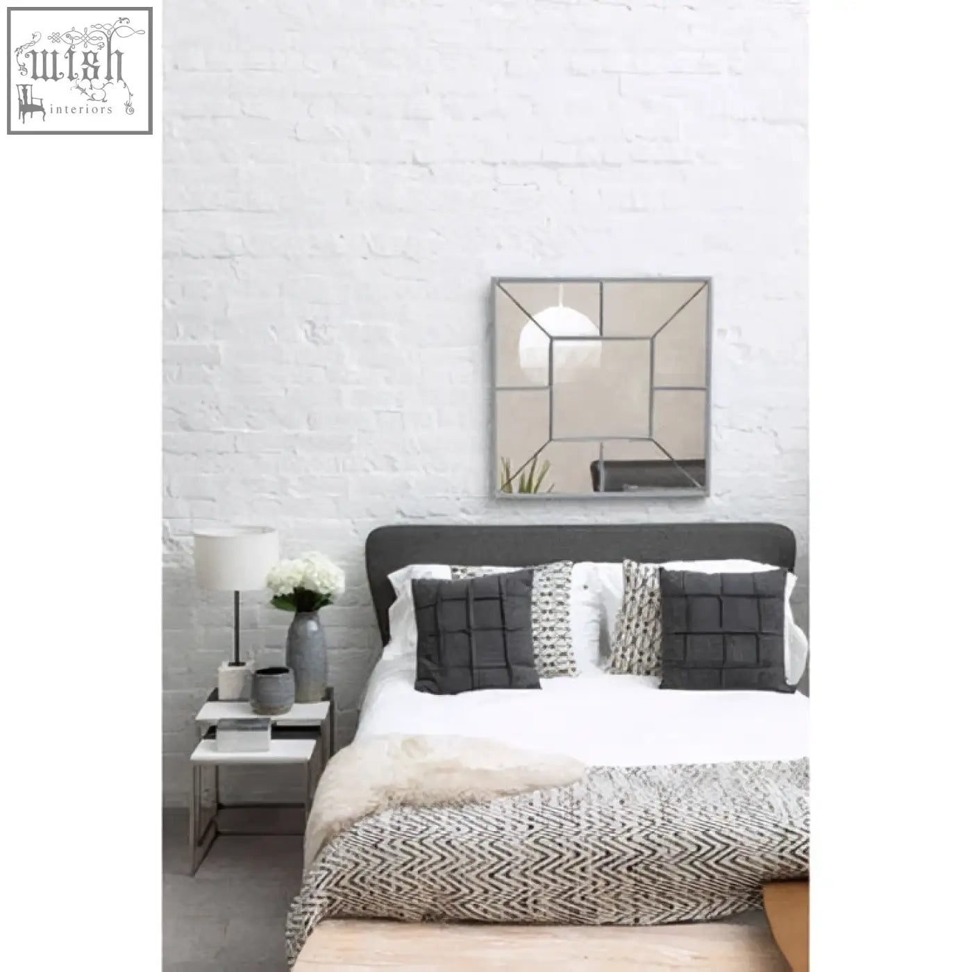 Large solar effect wall mirror with geometric mirrored panels and a silver-toned metallic frame
