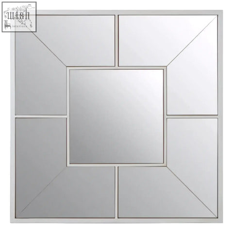 Silver-framed large solar effect wall mirror with geometric design and central square panel surrounded by angled segments