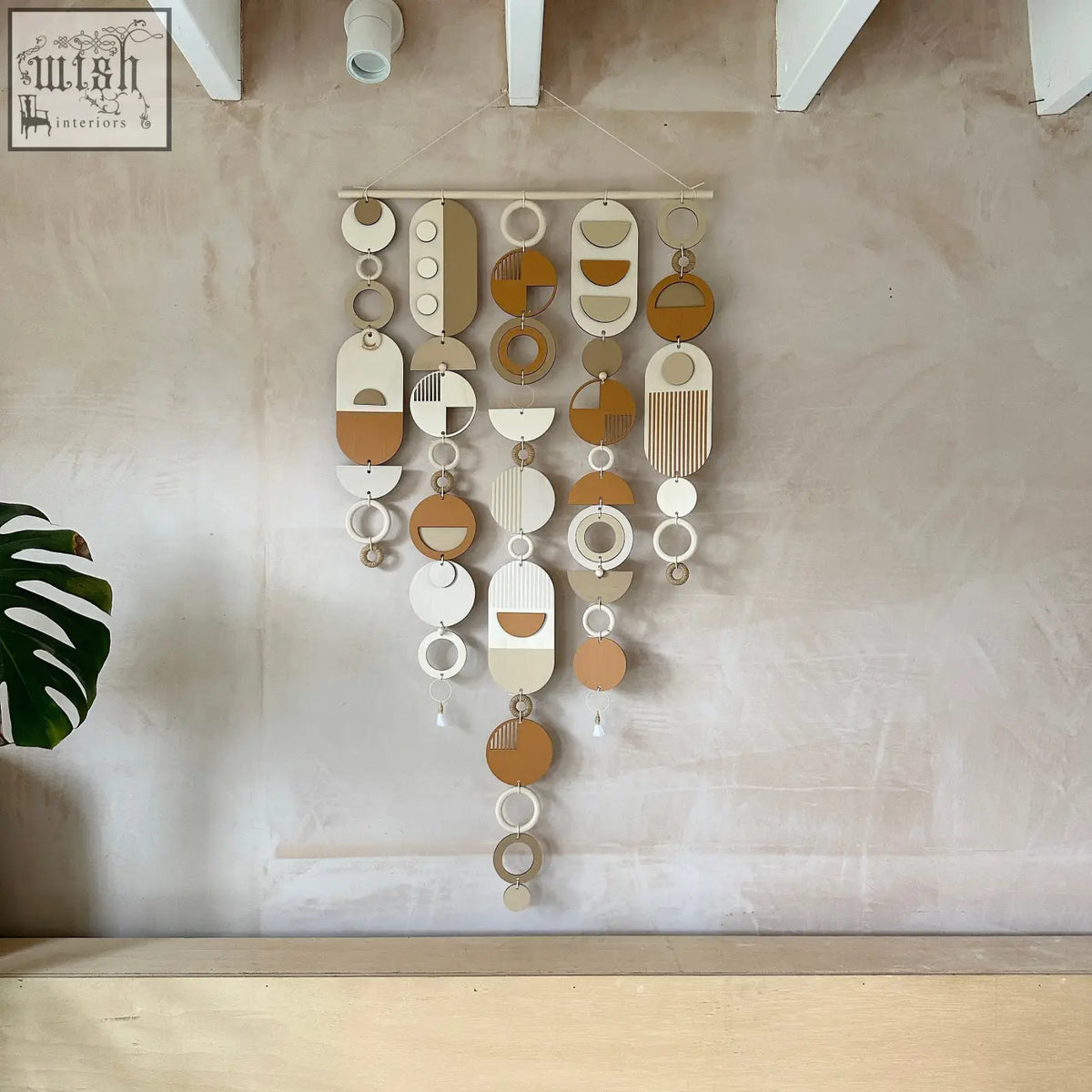 Desert sand wall hanging with hand painted engraved wooden discs in earthy tones for mid-century modern decor