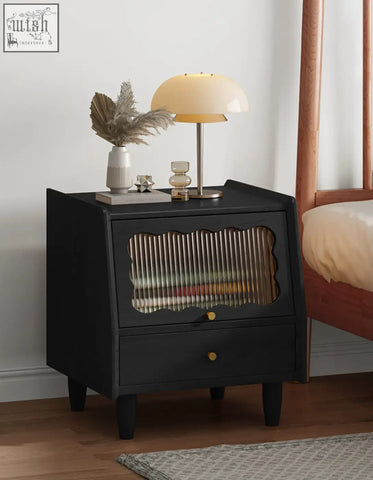 Black solid wood devin bedside table with scalloped glass panel and gold-tone knobs for stylish bedside use