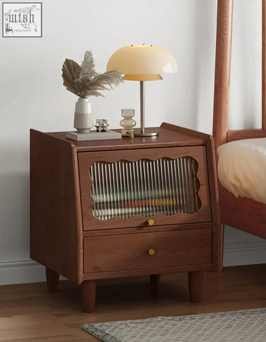 Warm-toned solid wood devin bedside table with scalloped glass panel and brass knobs bedside table design