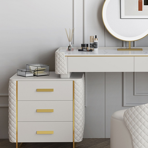 White quilted devorit dressing table with gold-tone drawer handles and slender legs for elegant storage