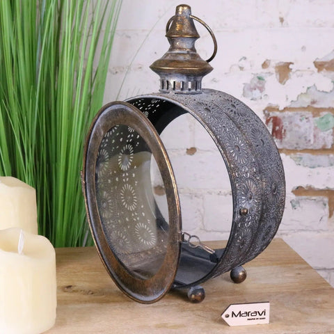 Devra vintage style round lantern with intricate floral metal cutouts and tarnished bronze finish for decor