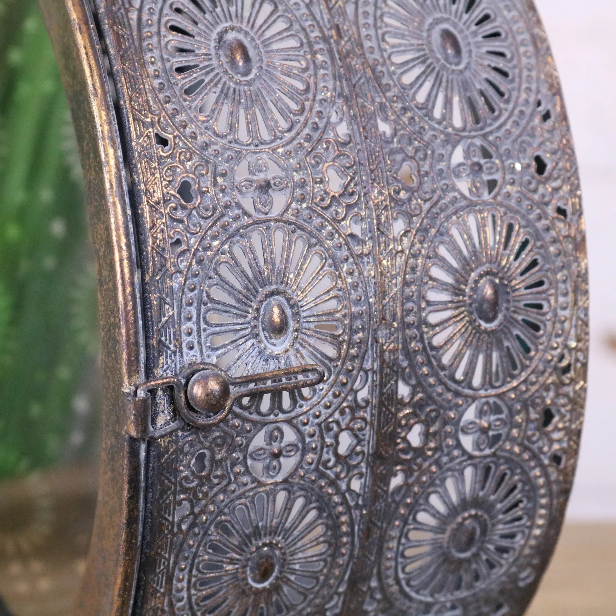 Antique-style metal mirror with intricate sunburst floral cutouts in distressed bronze patina for devra vintage style round lantern