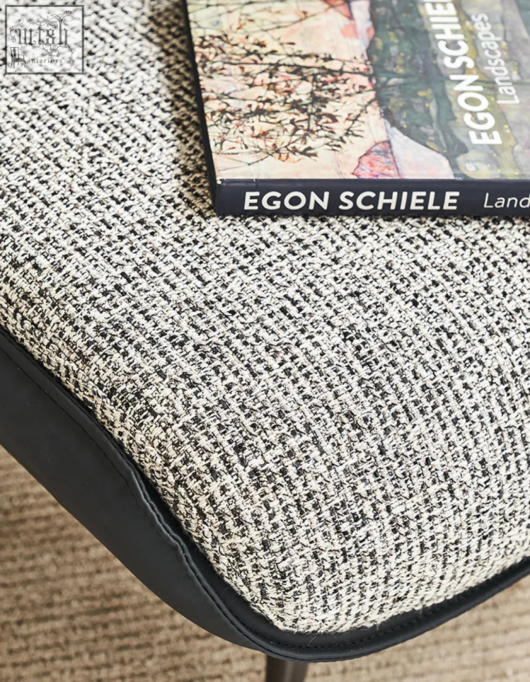 Textured gray and white tweed cushion with black leather trim for diakite armchair to upgrade your living space