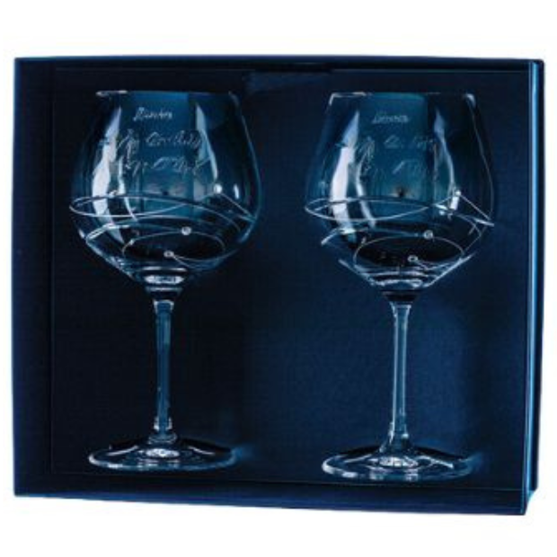 A pair of clear crystal gin glasses with spiral design etching and personalized inscriptions in a gift box