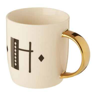 Cream-colored ceramic mug with gold-toned handle and black geometric pattern from diamond deco white collection
