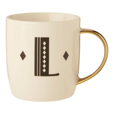 Cream-colored ceramic mug with gold-toned handle and black L monogram in diamond deco white design