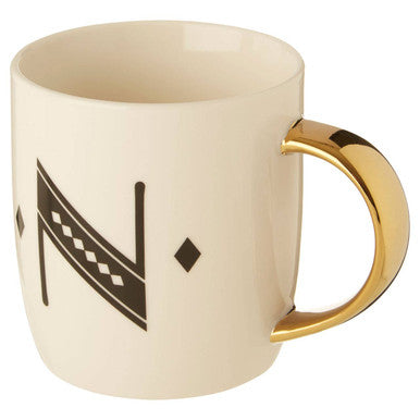 Cream-colored ceramic diamond deco white mug with gold handle and black geometric tribal deco white pattern