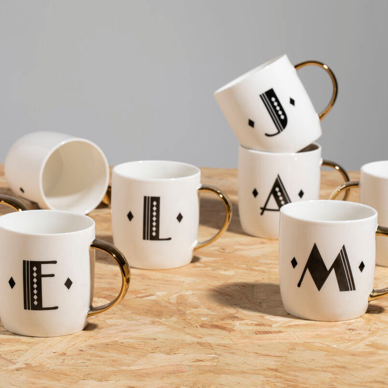 White ceramic diamond deco white monogram mug with gold handle and black letter r design