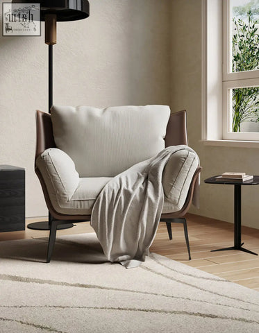 Beige dias armchair with corduroy upholstery brown leather accents and black metal legs perfect for stylish seating with low shipping cost
