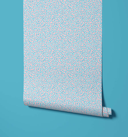 A roll of diego pink and light blue leopard print wallpaper with bold print wallpaper and visual texture details