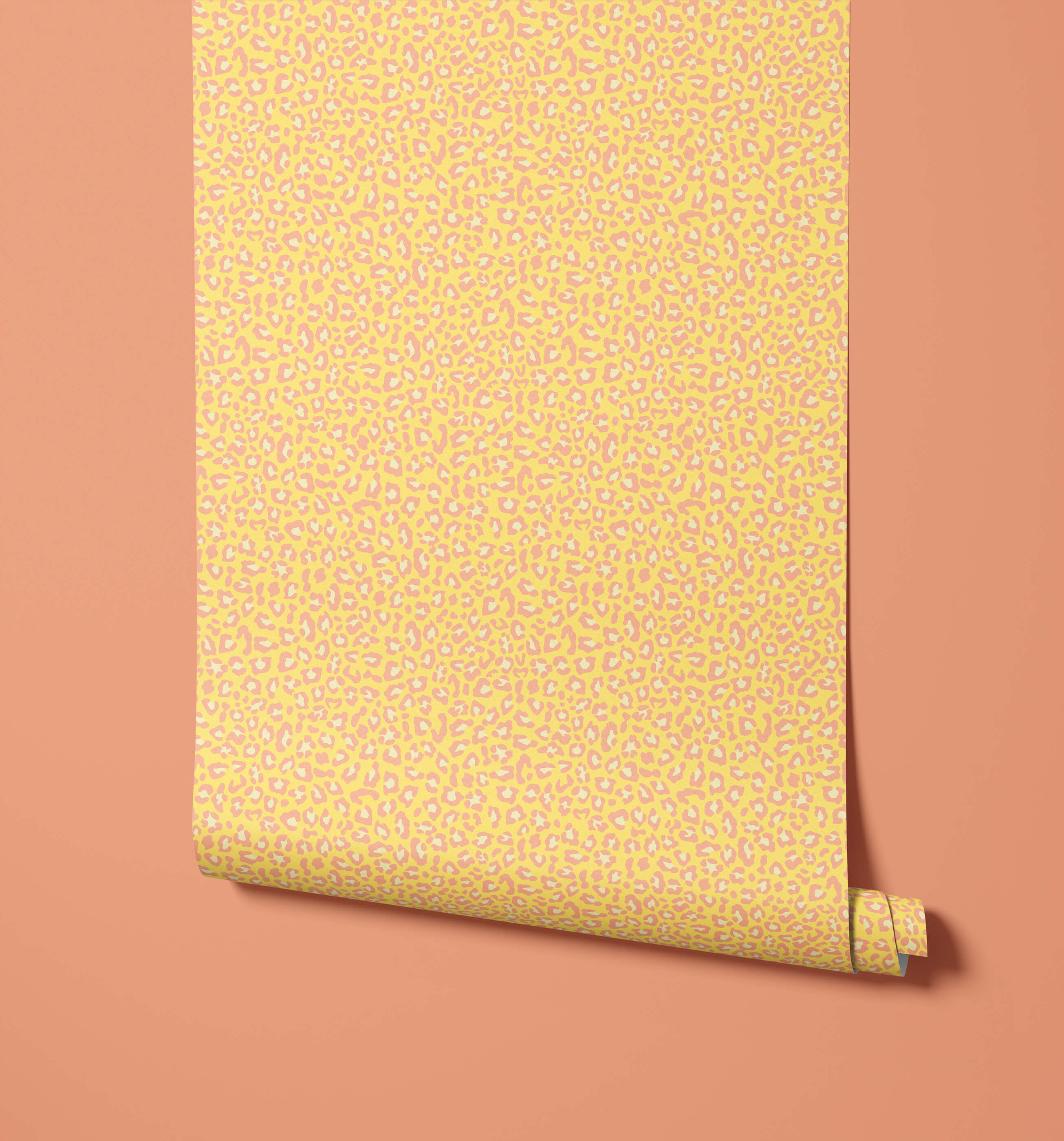 A roll of diego print wallpaper in vibrant yellow with subtle pink and white leopard print wallpaper visual texture