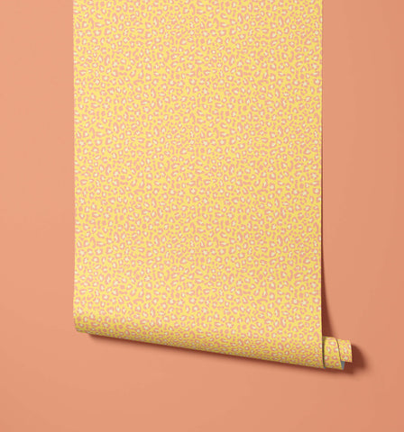 A roll of diego print wallpaper in vibrant yellow with subtle pink and white leopard print wallpaper visual texture