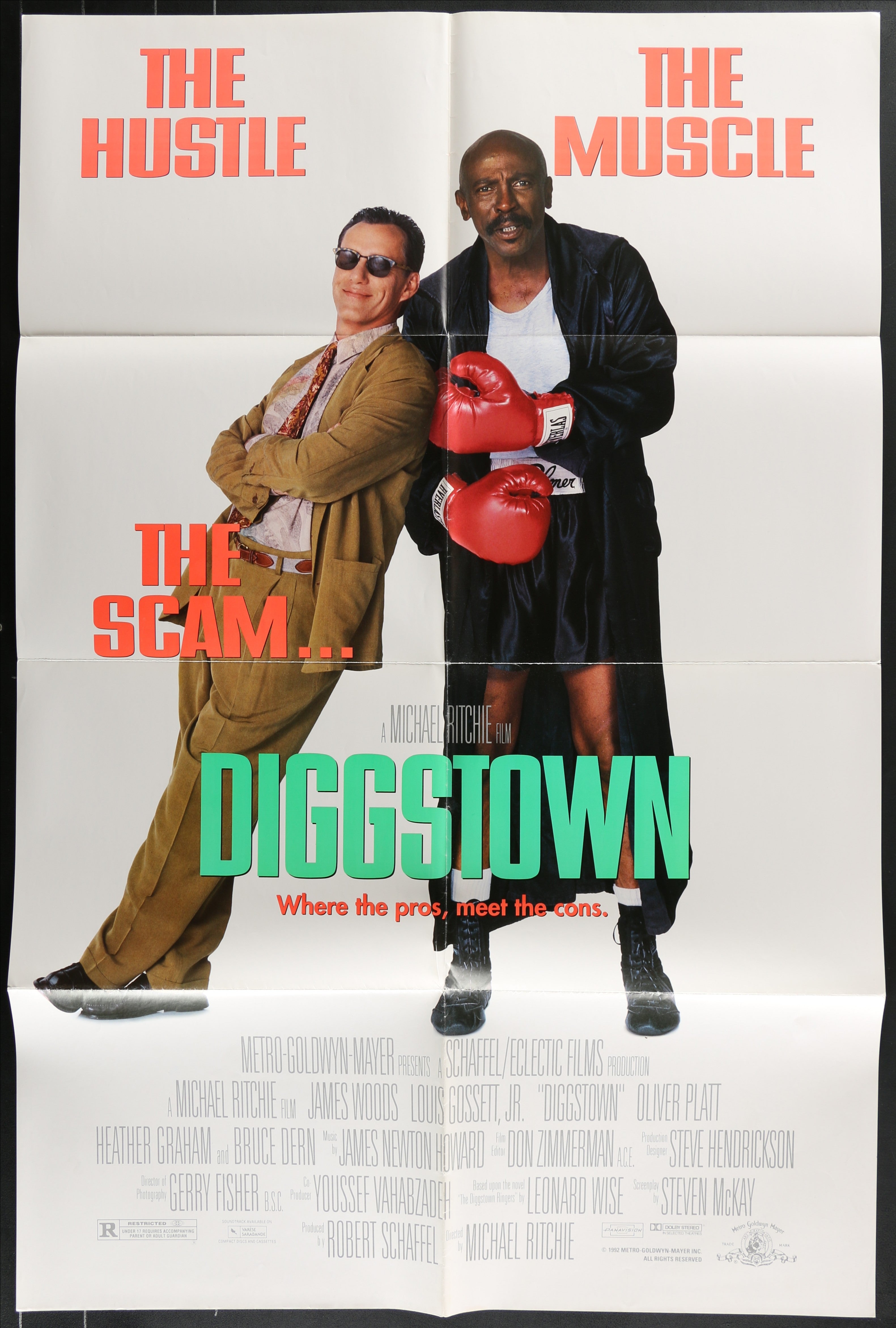 Movie poster for diggstown 1992 shows two men one in tan suit and sunglasses the other in black robe with red boxing gloves