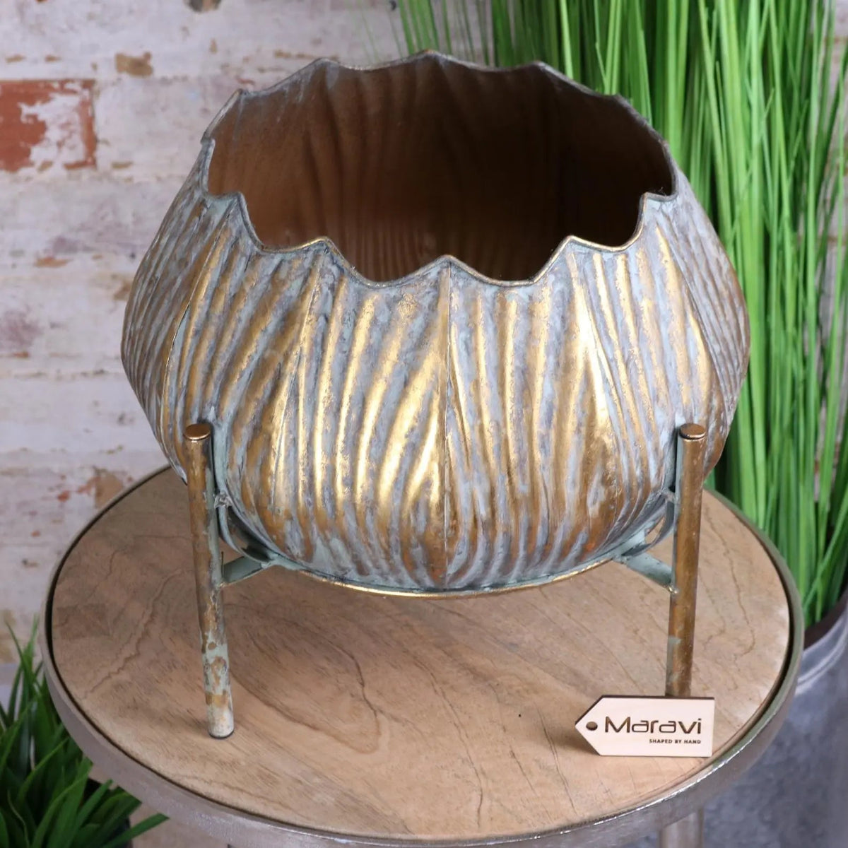 Metallic gold and silver dimma plant stand with scalloped rim and ribbed texture on slender brass legs