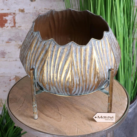 Metallic gold and silver dimma plant stand with scalloped rim and ribbed texture on slender brass legs
