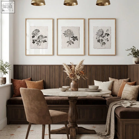 Round marble-top table with dark wood pedestal base paired with botanical chrysanthemum ink wall art prints for dining room