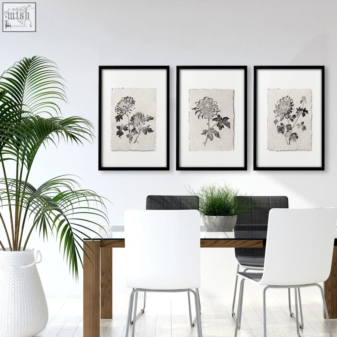 Three black-framed botanical wall art prints with inked chrysanthemum illustrations on off-white textured paper for dining room