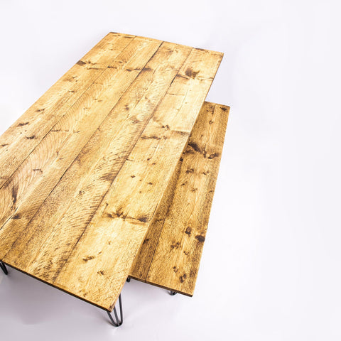 Rustic light oak dining table with black steel legs featuring visible wood grain and knots with free furniture care