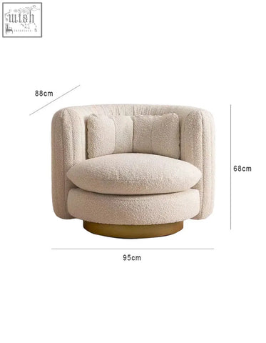 Cream-colored dino armchair features plush boucle fabric with a rounded design and gold-toned swivel base offer financing available