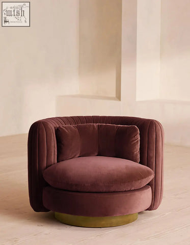 Dino armchair features plush burgundy velvet upholstery with a rounded tufted design and swivel gold-toned base offer financing available
