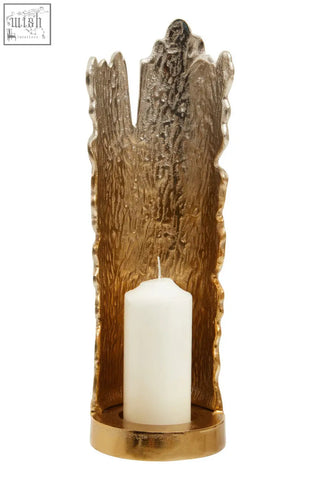 Gold-toned dion large ombre candle holder with tree-bark texture and white candle in large ombre silver style