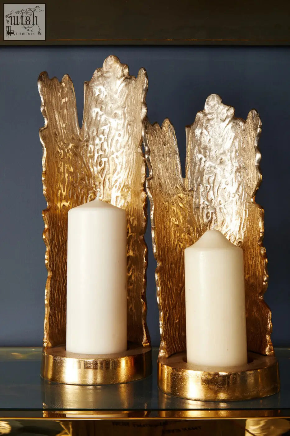 Gold-toned textured candle holder with rustic tree bark design holding white candles from dion large ombre silver gold