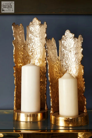 Gold-toned textured candle holder with rustic tree bark design holding white candles from dion large ombre silver gold